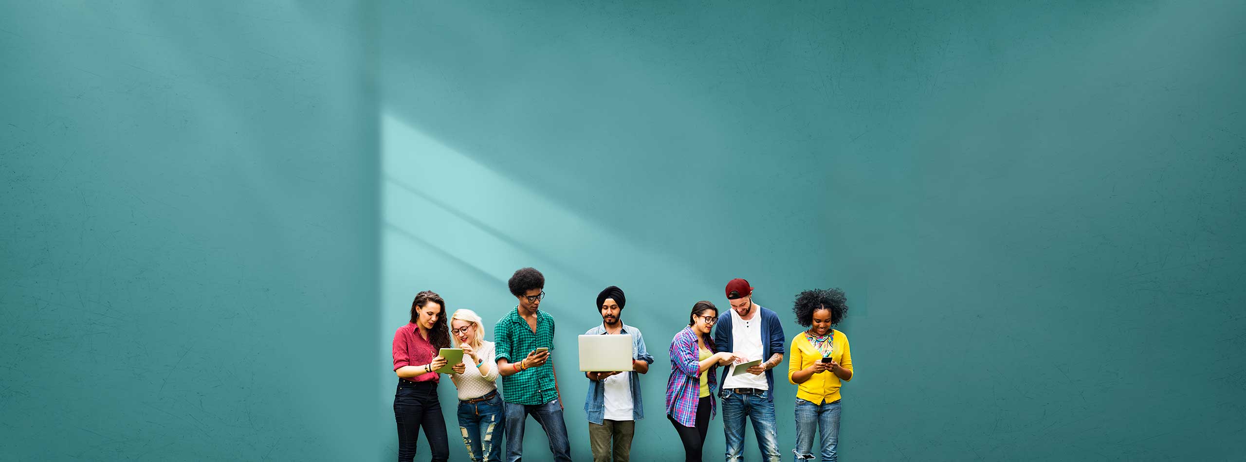 A group of diverse people looking at their laptop